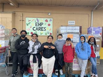 students in front of a sign that reads EHP Cares